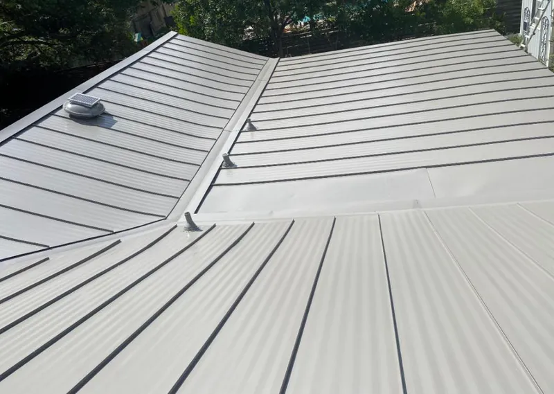 Solar attic fan installed on a metal roof for Roof Ventilation in Little Canada